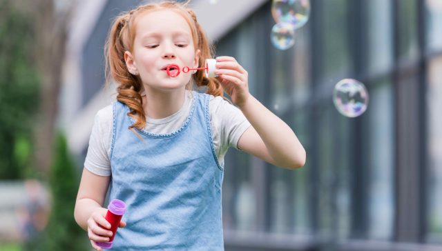 portrait-of-cute-child-blowing-soap-bubbles-on-str-2022-12-16-17-22-36-utc-1-640x364.jpg